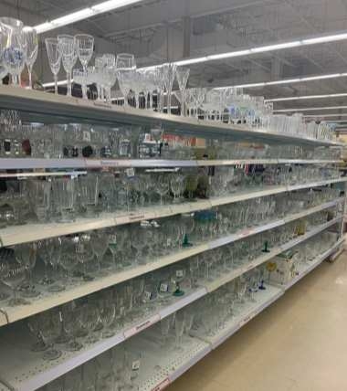 Xinghuo Glass Distributor The shelves of a Xinghuo glass distributor display a variety of custom-made glassware created by Xinghuo for its clients