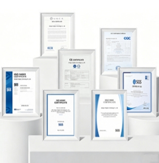 A photograph taken against a pristine white background showcases the company's 3D booth displaying its global compliance and internationally recognized quality certifications (Certified Quality for Global Markets). Seven international certification documents, each framed in elegant white, are arranged in a staggered, undulating fashion on several modern, miniature, white circular and rectangular geometric display stands. In the foreground, two certificates stand side-by-side: on the left, an ISO 45001 Occupational Health and Safety Management System certification with a blue geometric curved border; on the right, an ISO 9001 Quality Management System certification with the same design. Both certificates feature a clear black SGS logo at the bottom. On the left-hand, mid-ground display stand, stands an ISO 14001 Environmental Management System certification with a long, continuous blue color block. At the highest central display stand, arranged from left to right, are: UKCA certification, EU CE safety compliance certification, China CQC quality certification, and another international product inspection certificate issued independently by SGS in blue lettering. All the certificates are neatly formatted and appear extremely dignified and crisp under the soft, pure white light. The entire image is free of unnecessary distractions, perfectly showcasing the compliance foundation and core trust assets of this major foreign trade manufacturer in the fields of international green, low-carbon, and high-quality industrial manufacturing through its exquisite white geometric pedestal and multiple top international certifications.