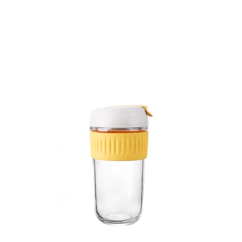 This product image, taken against a pristine white background, promotes the Xinghuo Glass Warm Yellow Anti-scalding Silicone Sleeve High Borosilicate Glass Coffee Tumbler. The highly transparent, straight-sided glass tumbler features a bright yellow, food