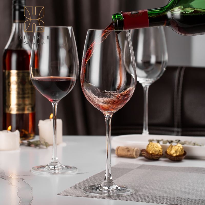 Dynamic display of pouring red wine into a crystal goblet.